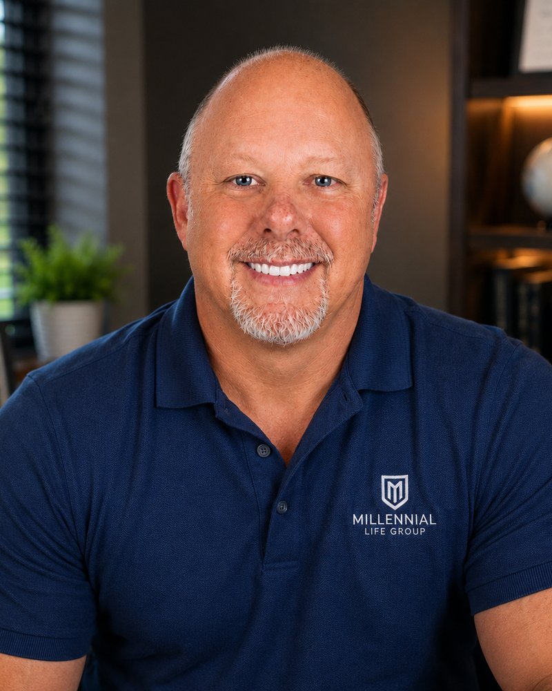 James Michael Kaufer smiling in a navy Millennial Life Group polo in an office