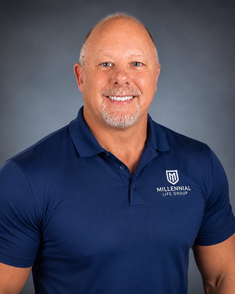 James Michael Kaufer, studio headshot in a navy Millennial Life Group polo